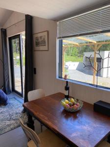 a dining room table with a bowl of fruit on it at Tiny house in the middle of nature in Åkersberga