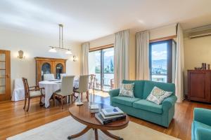 a living room with a green couch and a table at Suite 106 - Two bedroom apartment in Funchal