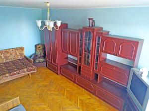 a living room with a red cabinet and a couch at Malishko in Kyiv