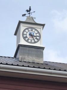 a clock tower on top of a building with a bird on it at Malvina House Hotel in Stanley