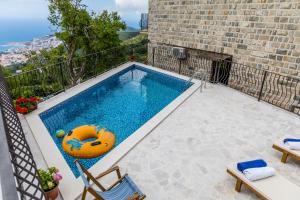a swimming pool with a pool noodle in a house at Villa Ladera Lapcici in Budva