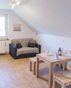 a living room with a couch and a table at Apartments Olip in Bled