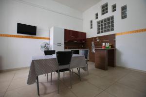 a kitchen and dining room with a table and chairs at Case Vacanze Racale in Racale