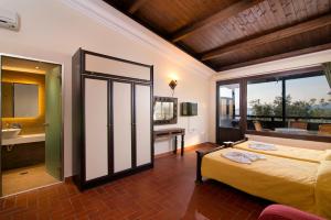 a bedroom with a large bed and a bathroom at Kallisti Hotel in Potos