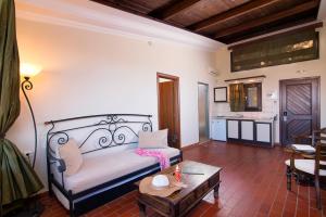 a living room with a bed and a table at Kallisti Hotel in Potos