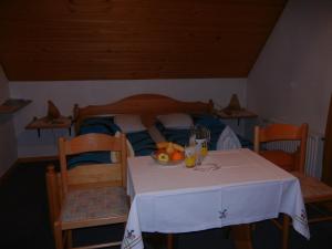a table with a plate of fruit on top of a bed at Apartments & Rooms Stare in Bohinj