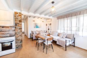a living room with a couch and a table at Oikia Petra in Agios Ioannis