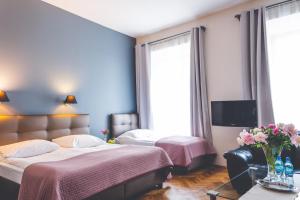 Posteľ alebo postele v izbe v ubytovaní Hotel Floryan Old Town