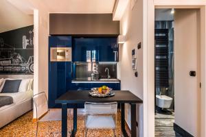a small kitchen with a table and a couch at Design Club Collection in Bologna +59 photos