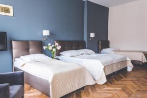 Posteľ alebo postele v izbe v ubytovaní Hotel Floryan Old Town