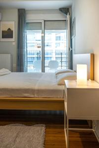 A bed or beds in a room at Modern 5BD Apartment in the Heart of Athens