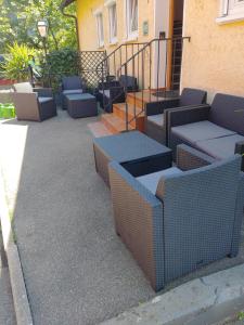 a group of chairs and tables on a patio at Pension Grübel in Lindau