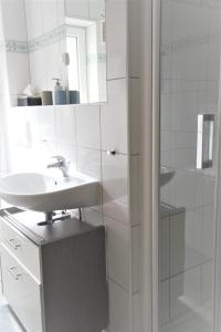 a white bathroom with a sink and a shower at Casa-Gorma at the beach, Apartment 121 in Zavala +37 photos