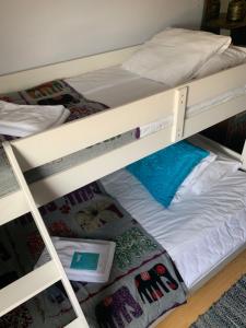 two bunk beds in a room with a bed at FlipFlop Beach Bar & Rooms in Falkenberg