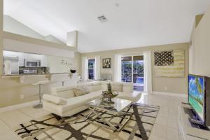 a living room with a white couch and a table at Villa Valmora in Cape Coral