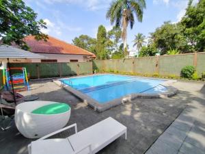 a swimming pool in a yard next to a house at Grand Mutiara Hotel Puncak in Bogor