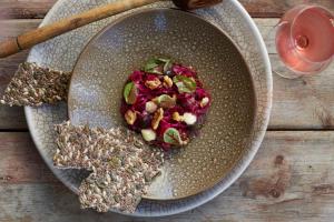 a plate of food with a salad on a table at Twelve Apostles Hotel & Spa in Cape Town +166 photos