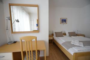 a bedroom with a bed and a desk and a mirror at Casa-Gorma at the beach, Apartment 121 in Zavala