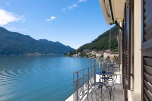 a view of a lake from a balcony of a building at Lac Hotel in Melide