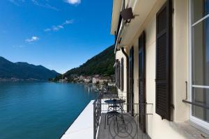 a balcony of a building with a view of a lake at Lac Hotel in Melide