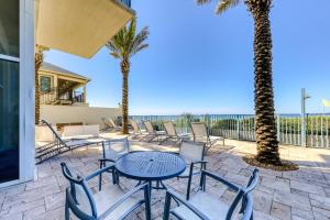 a patio with a table and chairs and the ocean at Sterling Breeze 3 in Panama City Beach