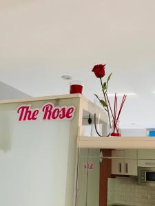 a red sign on top of a shelf with a rose at Atico Loft The Rose 48 in Cádiz
