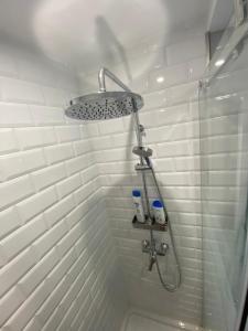 a shower with a shower head in a bathroom at Atico Loft The Rose 48 in Cádiz