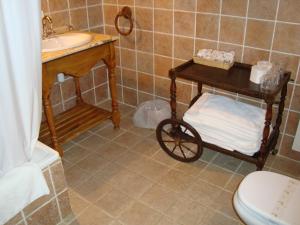 a bathroom with a sink and a cart with towels at Hotel Charle in Jaca