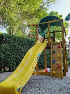 a playground with a slide and a play structure at Vila Aqua in Eforie Sud