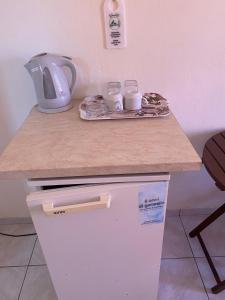 a kitchen table with a cup of coffee and a microwave at Romantic Spa Resort in Fira