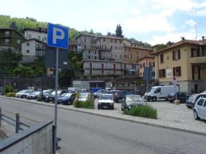 a parking lot with cars parked on the side of a street at Ca Bossa Molina in Faggeto Lario 