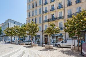 a street in front of a large building at Les Floralies Capucines in Marseille