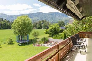 a balcony with a view of a field and mountains at Apartments Olip in Bled