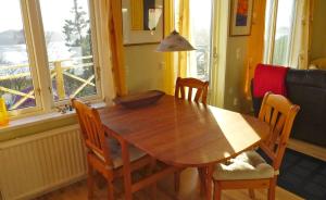a wooden table and chairs in a room with a window at Riddarhuset in Ljungskile