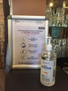 a bottle of soap sitting next to a sign at Le Parvis in Chartres