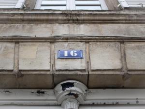 a blue sign on the side of a building at Trankil Apparts centre in Saint-Quentin