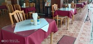 a row of tables and chairs in a restaurant at Stefan's Guesthouse in Jomtien Beach