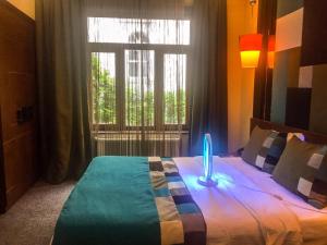 una camera da letto con un letto con una candela blu sopra di Collage Pera Hotel a Istanbul