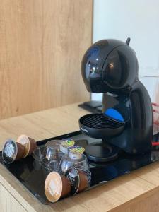 a coffee maker on a tray on a counter at NerjaRooms in Nerja