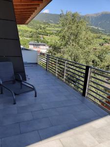 a balcony with a chair and a view at Garni Maria in Varna