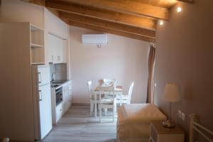 a kitchen and dining room with a table and chairs at Studios Artemis in Lefkada Town
