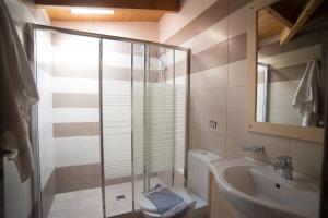 a bathroom with a shower and a toilet and a sink at Studios Artemis in Lefkada Town