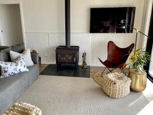 a living room with a couch and a fire place at The Cape in Emu Bay