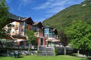 a large building with a mountain in the background at Club Hotel Tenno in Tenno