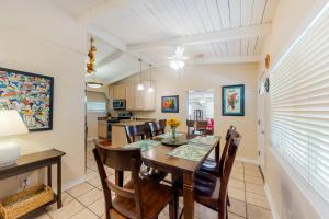 a kitchen and dining room with a table and chairs at Twin Lake Lookout in Panama City Beach