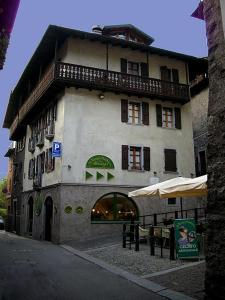a large building with a store in front of it at Albergo Al Tempo Perduto in Bagolino