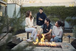 a group of people sitting around a fire pit at Carneros Resort and Spa in Napa