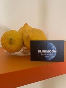 a bowl of fruit on a shelf with a sign at Blue Moon GuestHouse in Lagos