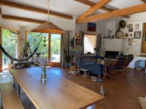 a living room with a wooden table and chairs at Côté Chênes Verts - Chambres d'hôtes in Viols en Laval