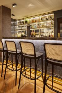 a group of chairs sitting at a bar at Hotel SANSEbay in Donostia-San Sebastián